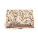 A Chinese white metal cigarette case with relief dragon decoration