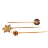 Three stick pins including a 9ct gold stone set,