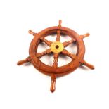 A wooden and brass ships wheel