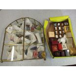 A display case of decorative ceramic butterflies plus various thimbles