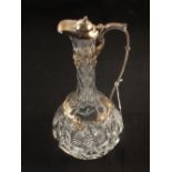 A cut glass claret jug with silver handle,
