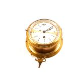 A circular brass ships clock