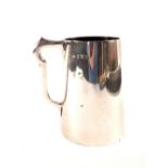 A silver pint tankard of plain form,