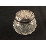 A small silver top glass jar,