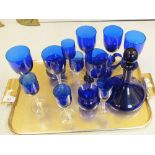 A blue glass decanter plus other blue glass