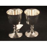 A pair of silver goblets (one base is dented)