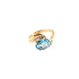 A 9ct gold blue topaz and diamond set ring,