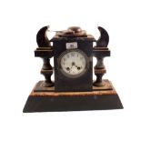 A Victorian black and variegated marble striking mantel clock