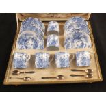 A boxed Royal Crown Derby blue and white bird decorated coffee set with five silver spoons