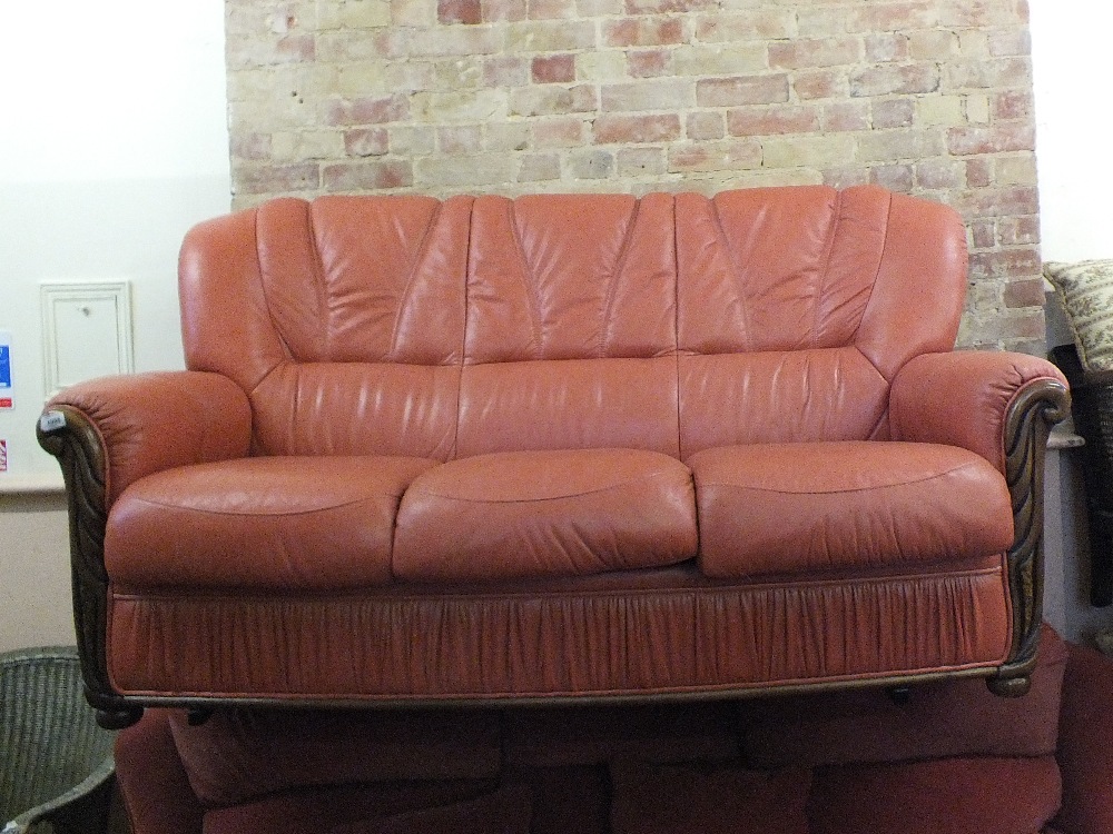 A modern Italian style wood and terracotta leather upholstered sofa