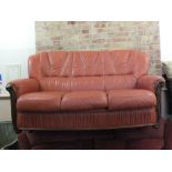 A modern Italian style wood and terracotta leather upholstered sofa