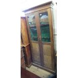 An oak floor standing twin door partially glazed display cabinet with interior converted to fit for