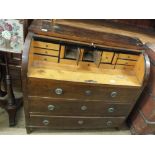 A pine roll top desk with fitted interior and three long drawers below