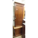 A mahogany single door cabinet on a larger mahogany single door cupboard base,