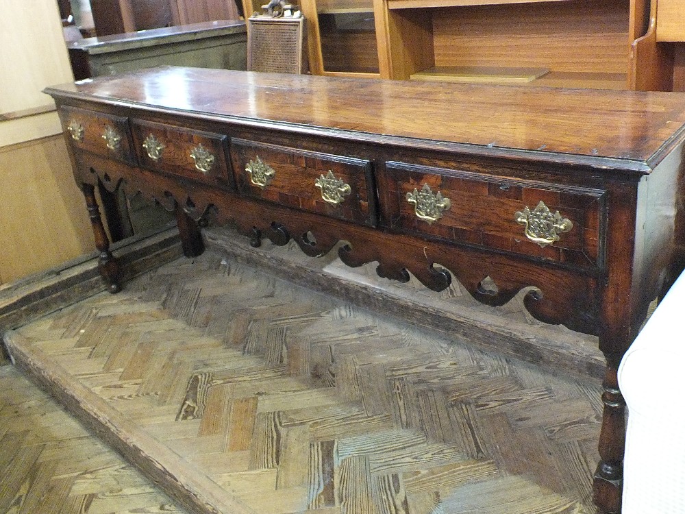 A Regency style oak sideboard with four drawers, brass handles,