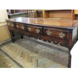 A Regency style oak sideboard with four drawers, brass handles,