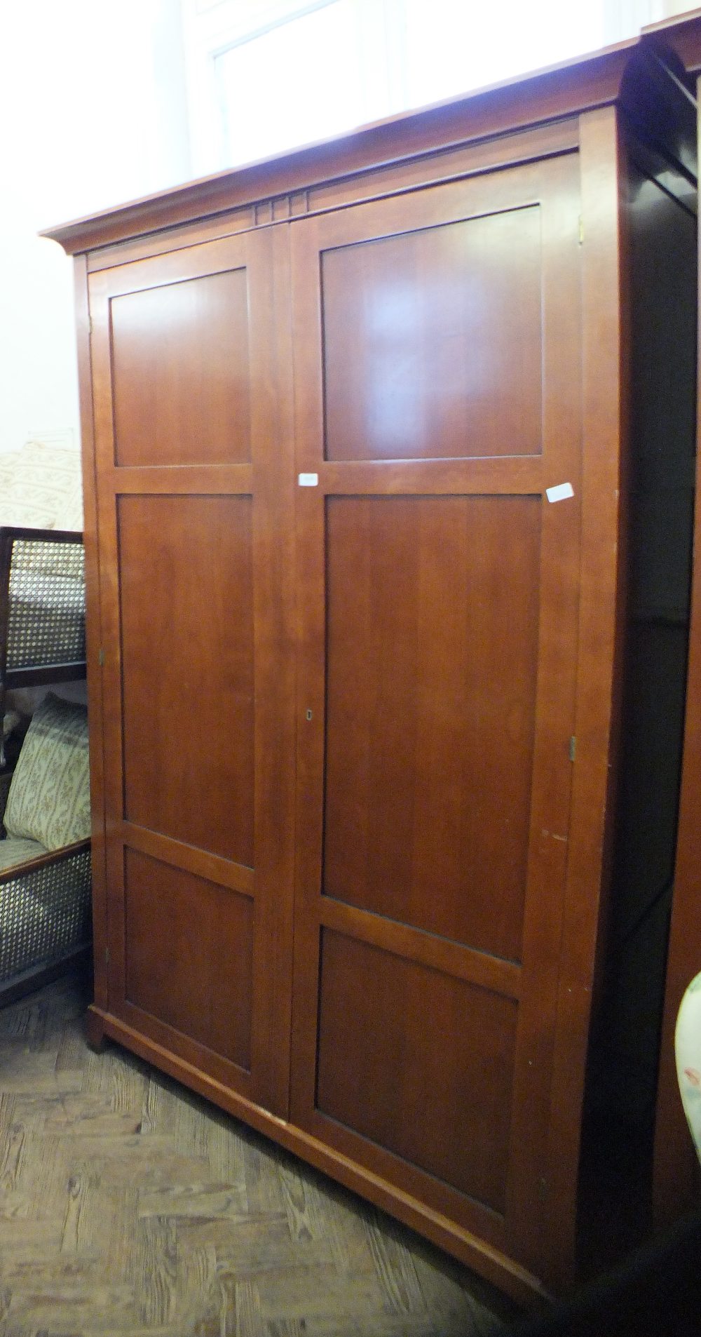 A large modern stained two door wardrobe