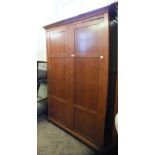 A large modern stained two door wardrobe