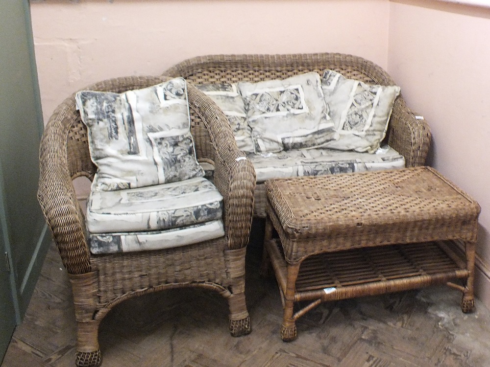 A wicker conservatory suite comprising a two seater sofa,