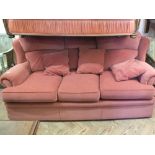 A modern terracotta upholstered three seater sofa