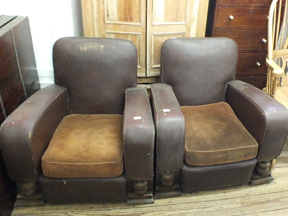 A pair of vintage brown leatherette and wooden framed armchairs