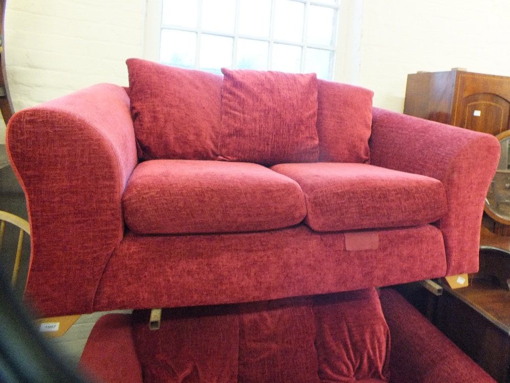 A modern dark red upholstered two seater sofa