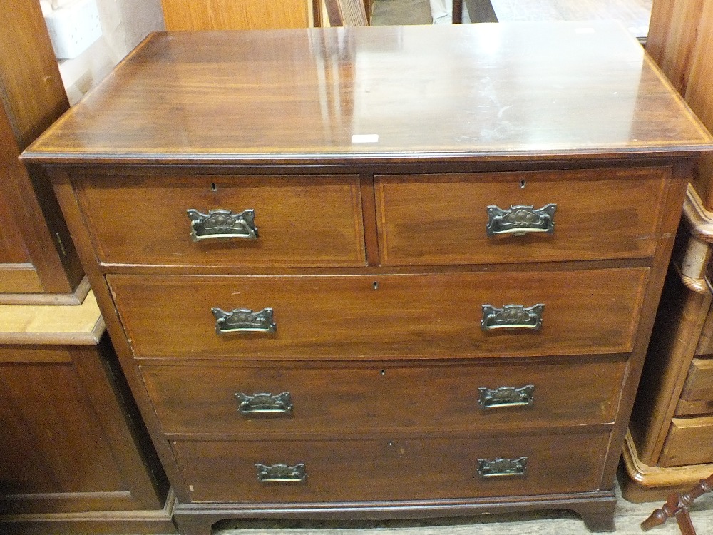 An Edwardian mahogany cross banded chest of two short and three long drawers with Art Nouveau brass