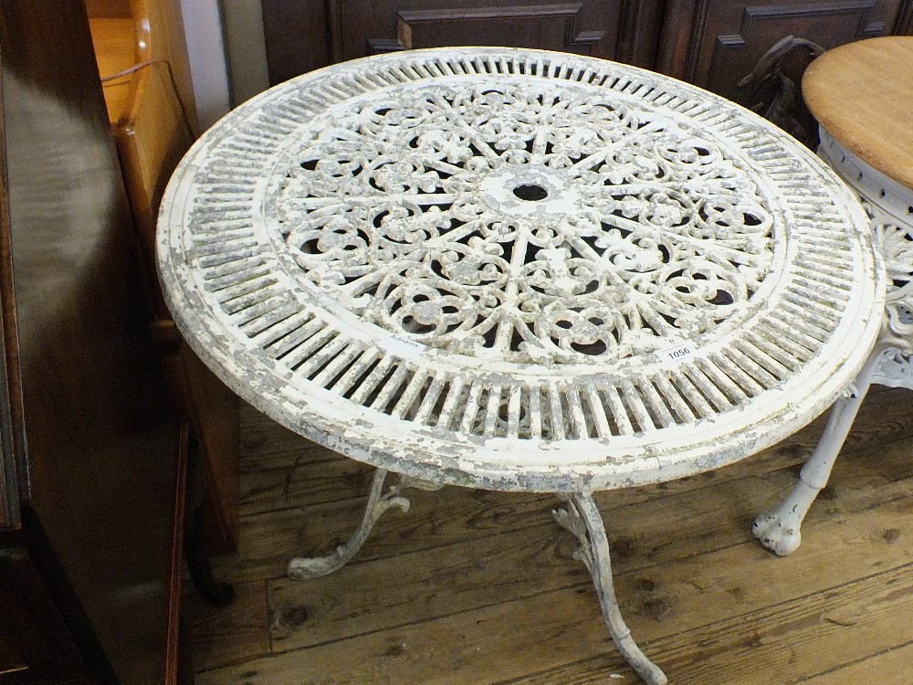 A white painted cast aluminium garden table