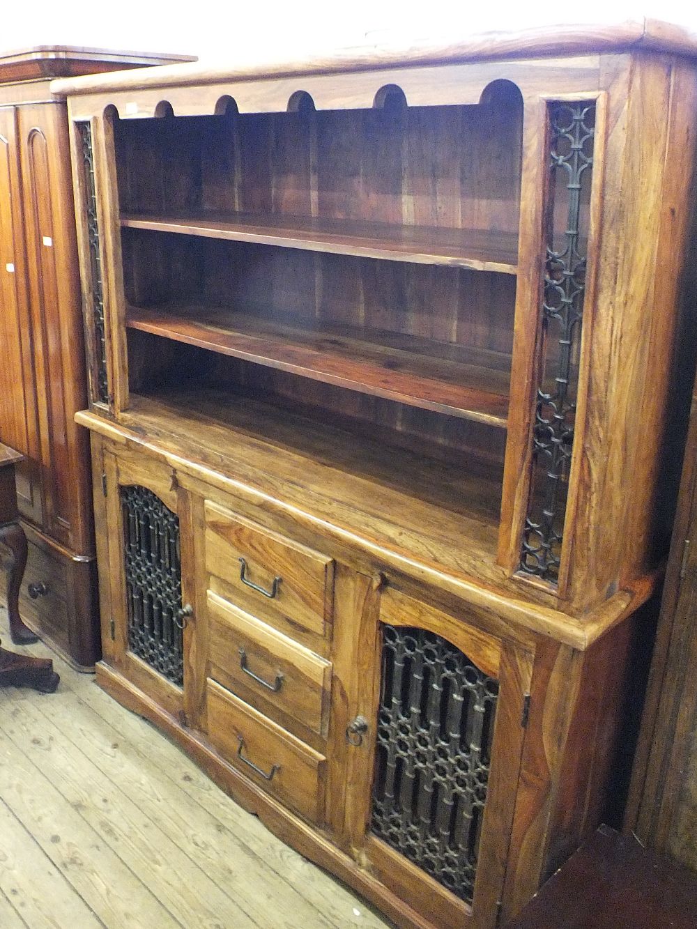 A modern Eastern style mangowood and wrought iron dresser bookcase with two doors and three drawer