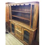 A modern Eastern style mangowood and wrought iron dresser bookcase with two doors and three drawer