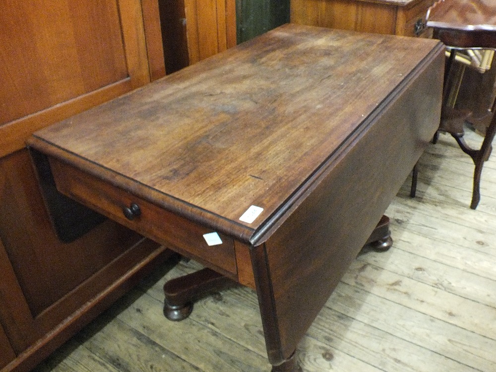 A Victorian mahogany Pembroke table with a single drawer and faux drawer on column stand and