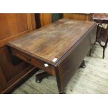 A Victorian mahogany Pembroke table with a single drawer and faux drawer on column stand and