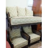 A carved Bergere two seater sofa and two matching armchairs