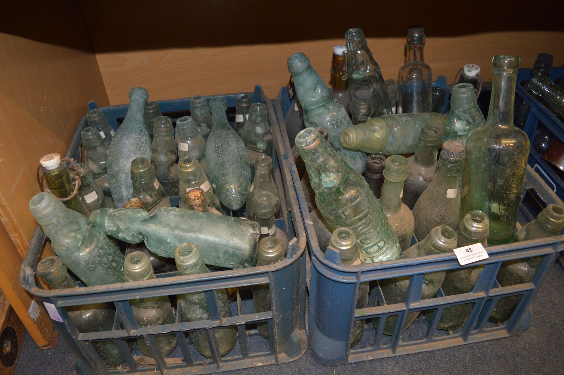 Two Crates of Victorian and Edwardian Aqua Glass Bottles Including Codds Bottles