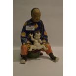 Chinese Pottery Figurine "Man with Child"