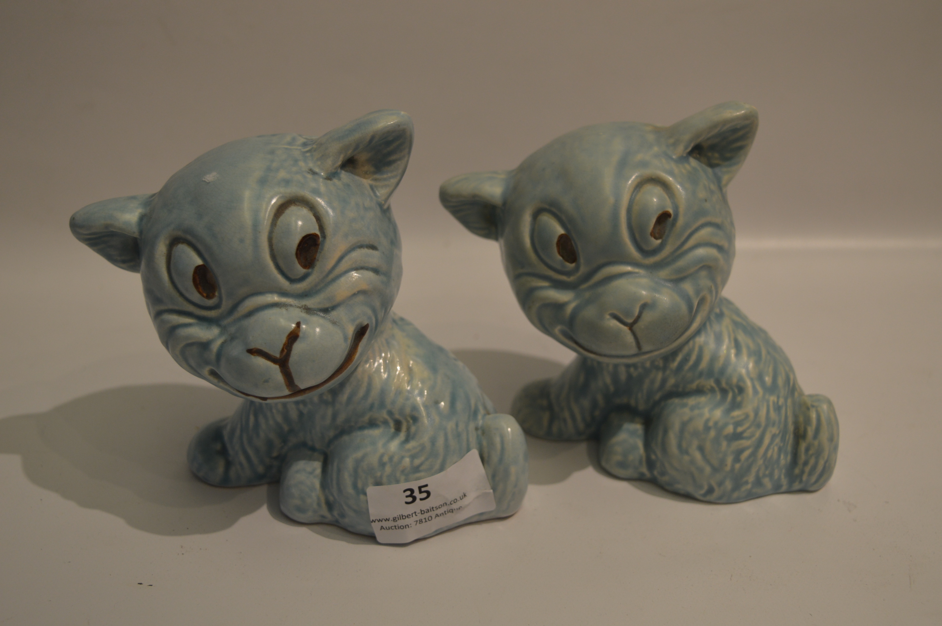 Pair of Blue Pottery Grinning Dogs