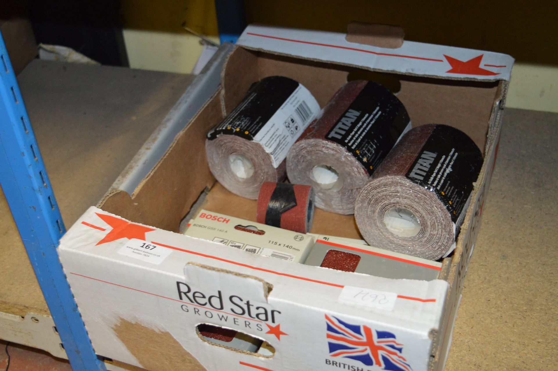Box Containing Three Titanium Oxide Paper Rolls and Four Bosch GSS140 Sanding Pads