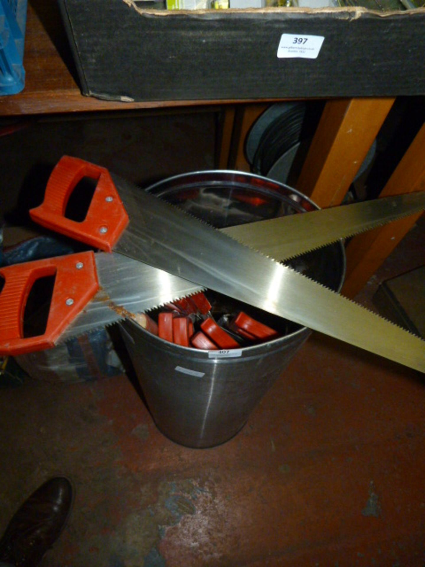 Stainless Steel Bin Containing Hand Saws and a Cricket Bat