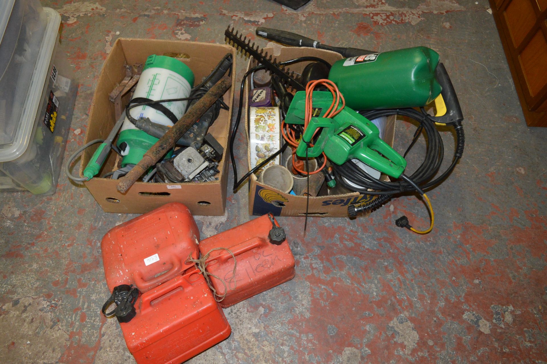 Two Boxes of Tools Including Large Drill, Petrol Cans, Chainsaw, Fence Sprayer, etc.