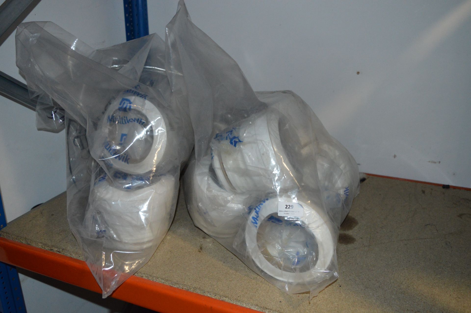 Two Bags Containing Toilet Outflow Connectors