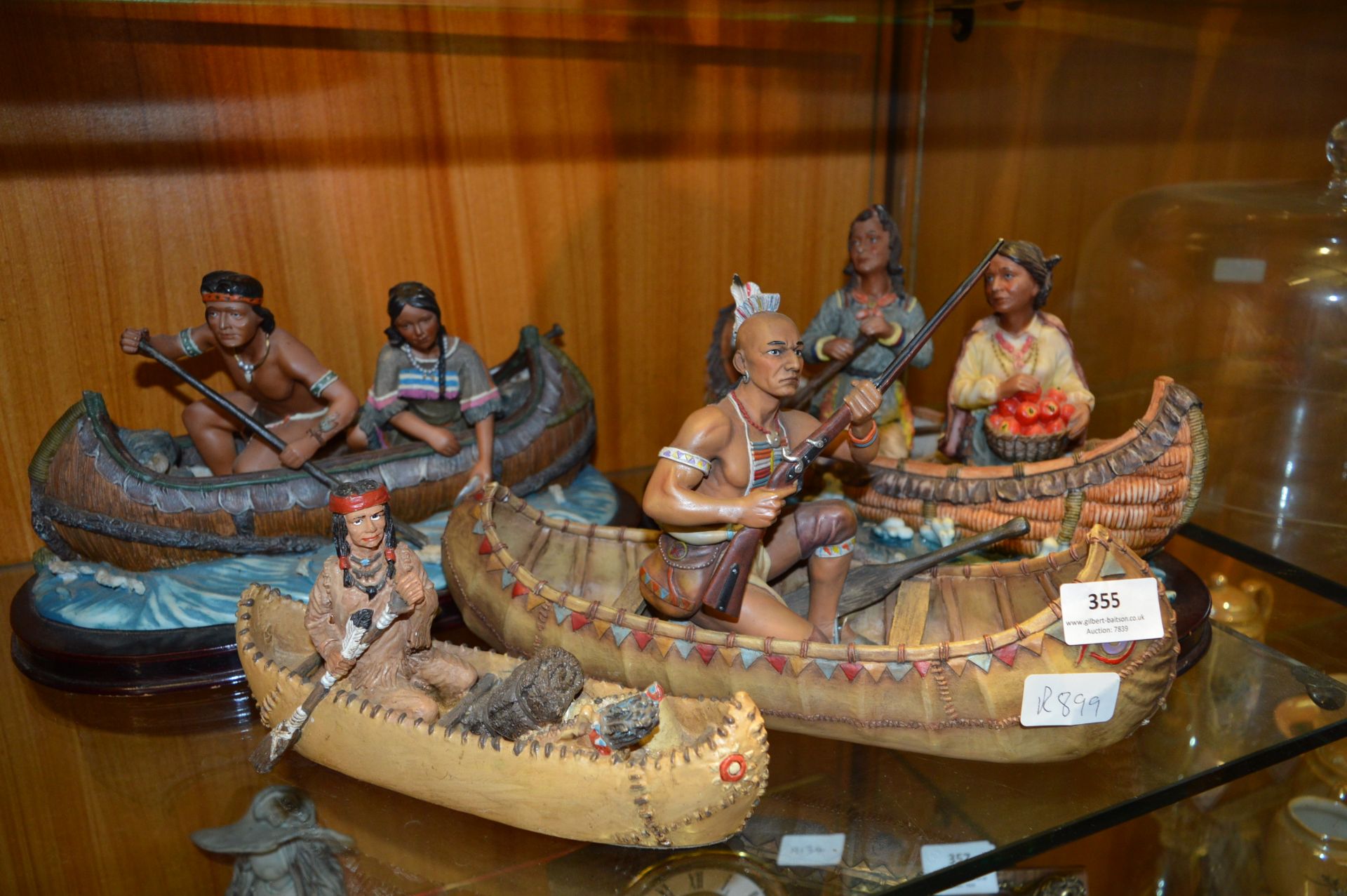Four Native American Figurines in Canoes