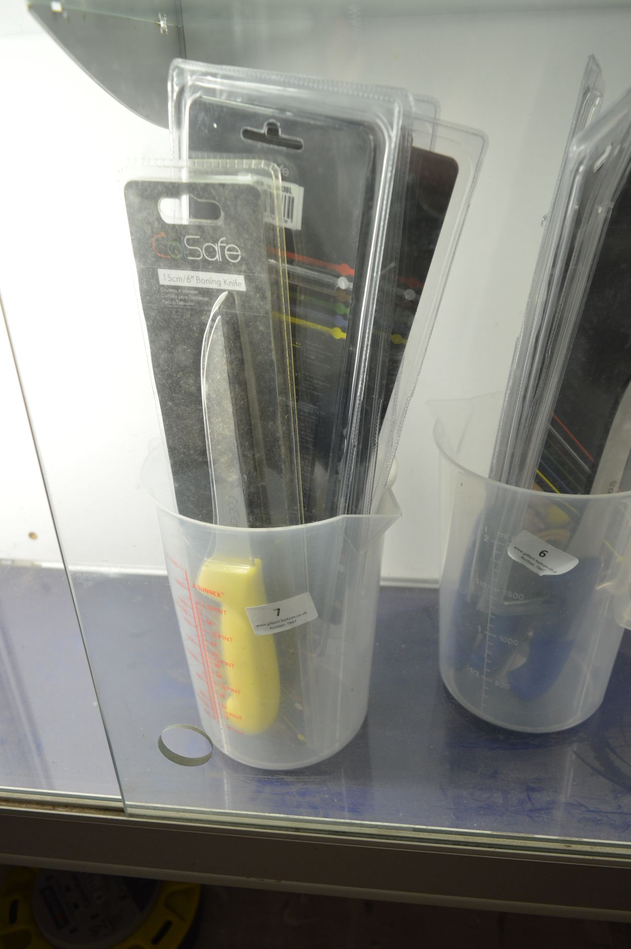 Plastic Jug Containing Five Chefs Knives