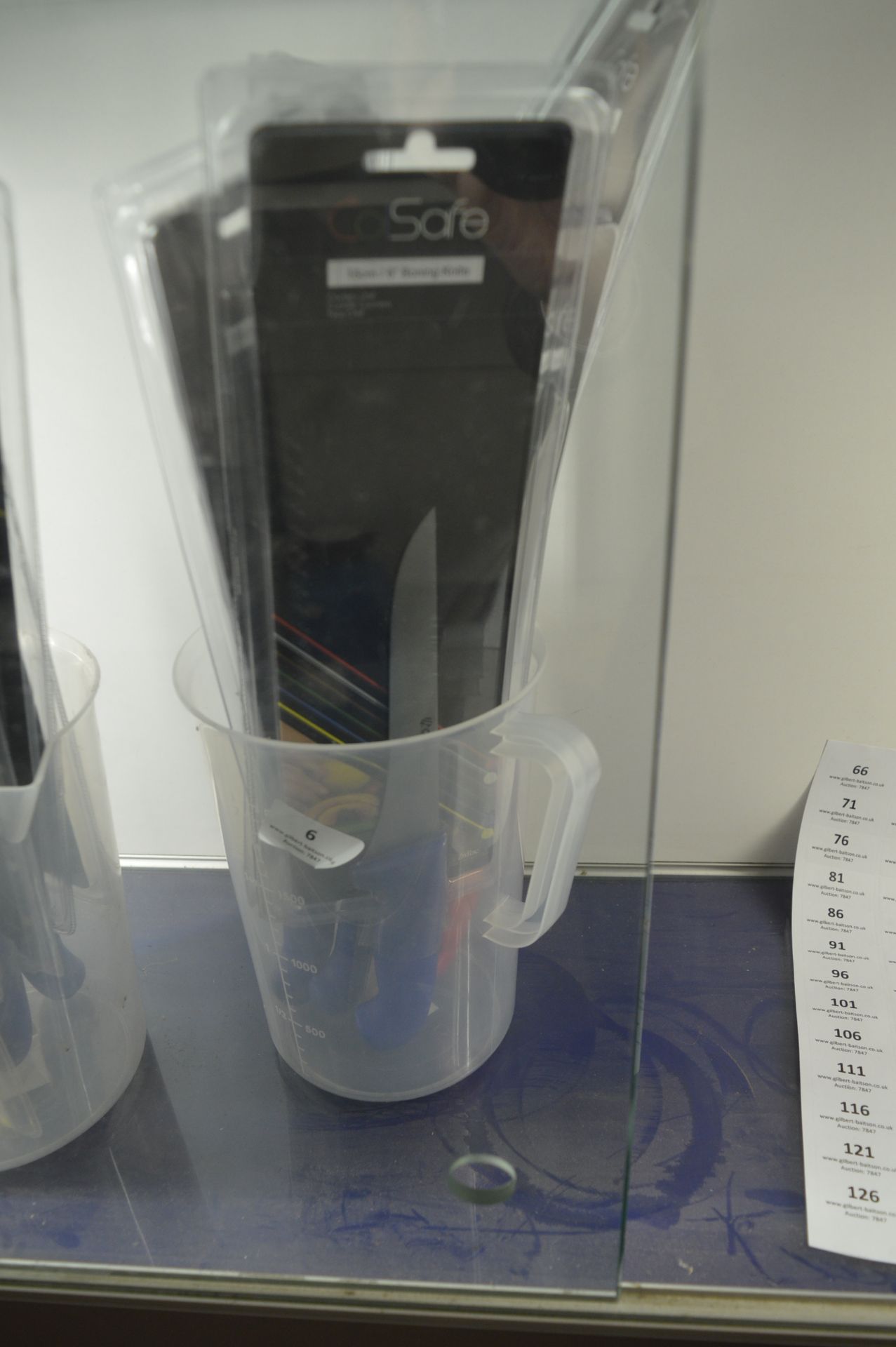 Plastic Jug Containing Five Chefs Knives