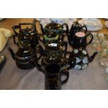 10 Assorted Gilt & Floral Black Pottery Teapots & Jug