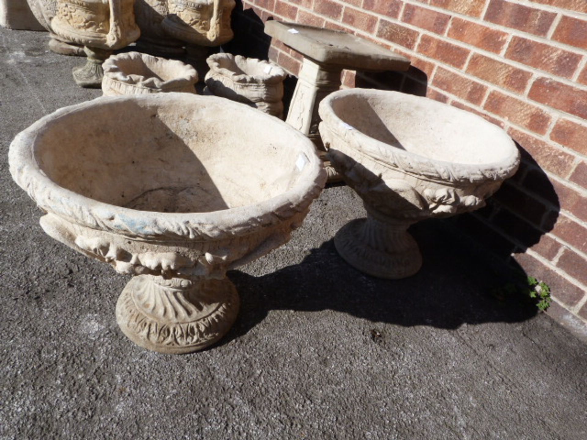 Pair of Reconstituted Limestone Garden Urns on Plinths