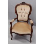 A Continental stained beech open armchair, in the French style, with a padded back, arm rests and