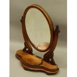 A Victorian figured mahogany dressing table mirror, with an oval plate, the shaped base with a