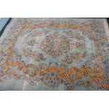A large European carpet, with a design of flowers, scrolls, etc, on a pale blue ground, 430cm x