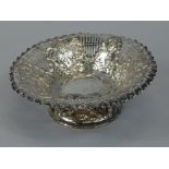An Edwardian pierced silver bowl, decorated in Adam, with roundels, swags etc., on a domed foot,