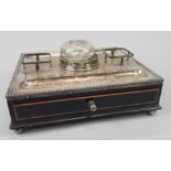 A 19thC ebonised brass inlaid ink stand, with silver plated mounts for ink wells, pens, etc, with